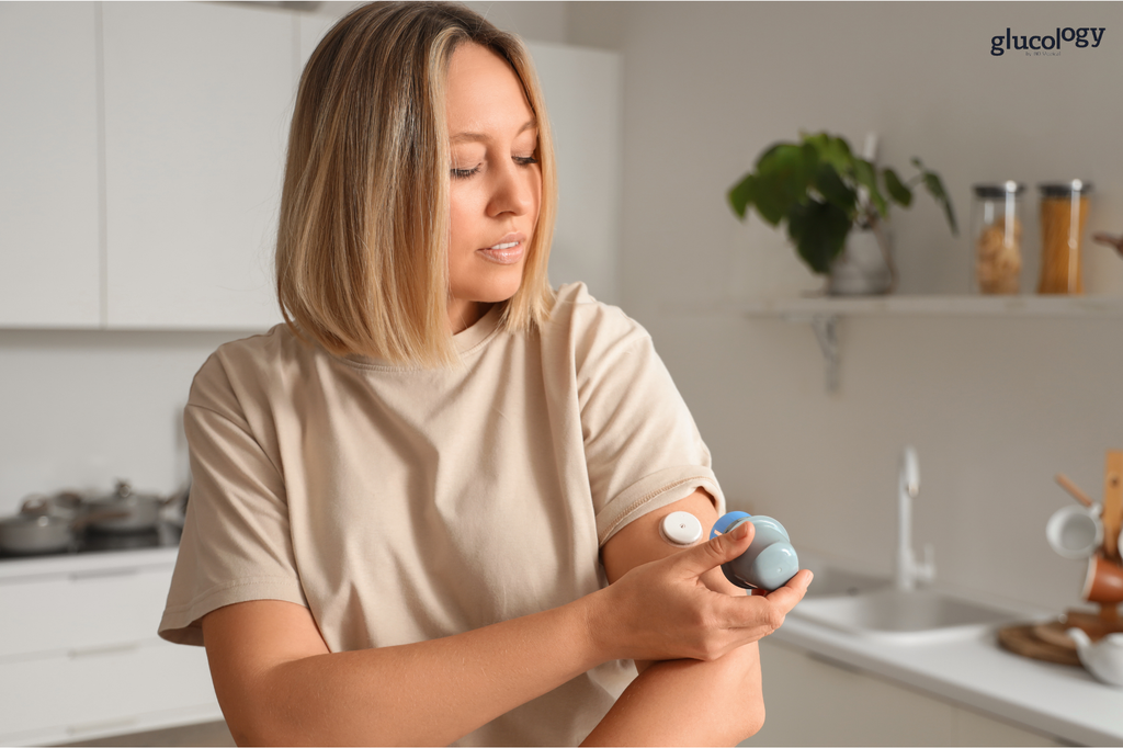 oman applying a continuous glucose monitor (CGM) to the back of her upper arm.